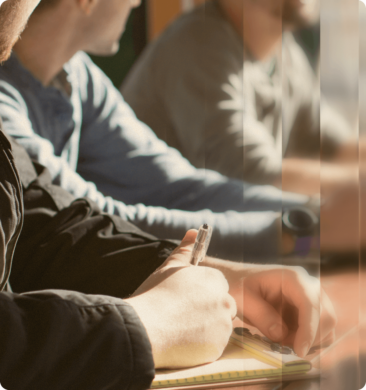 Person taking notes in a notebook during strategic planning session