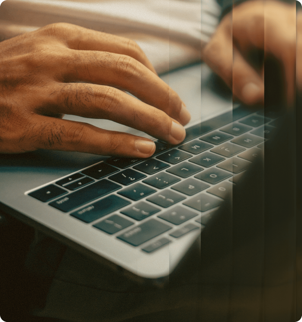 Hands typing on laptop keyboard during workflow implementation