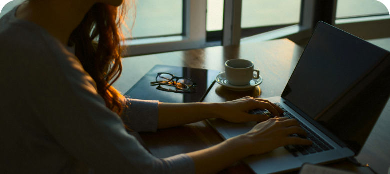 Professional working focused at laptop in calm, organized workspace
