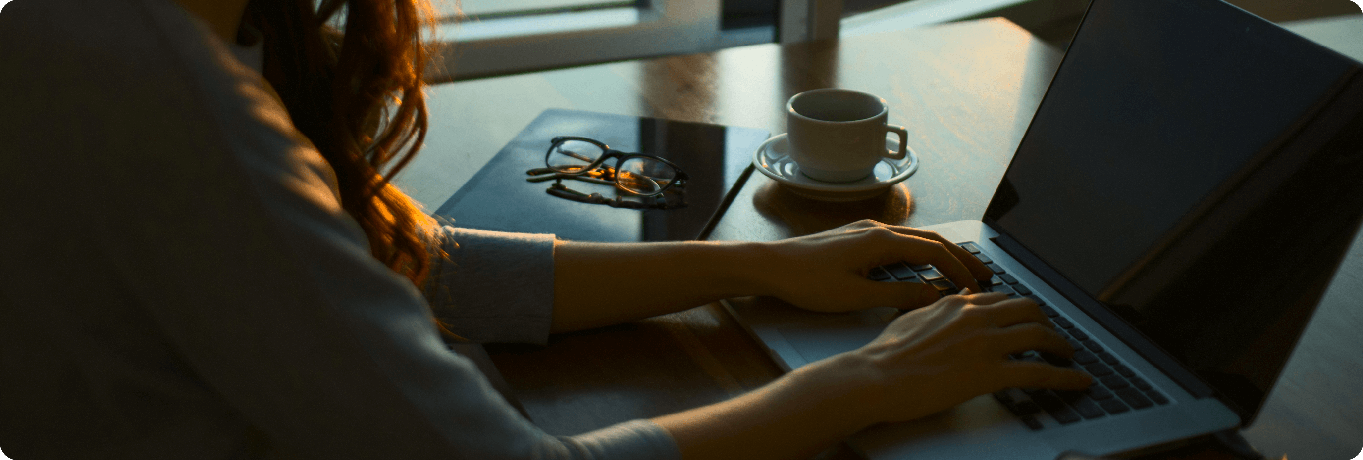 Professional working focused at laptop in calm, organized workspace